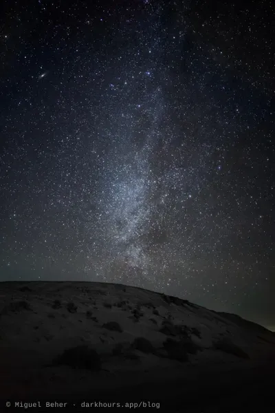 Winter Milky Way and the Andromeda Galaxy over a sand dune at the Knolls