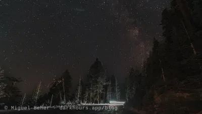 Milky Way over a forest road lit by headlights on Mt Ashland, Oregon