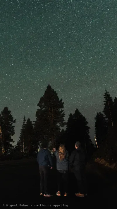 Three stargazers under a dense star field on Mt Ashland, Oregon