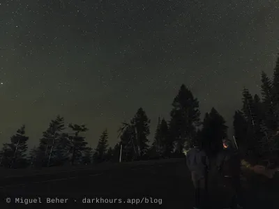 Two stargazers looking up from the road on Mt Ashland, Oregon